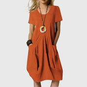 Elaine Rossmore | Orange V-Neck Midi Dress with Pockets