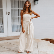 Allegra Vossbourne | Strapless Tie Waist Wide Leg Jumpsuit in Beige