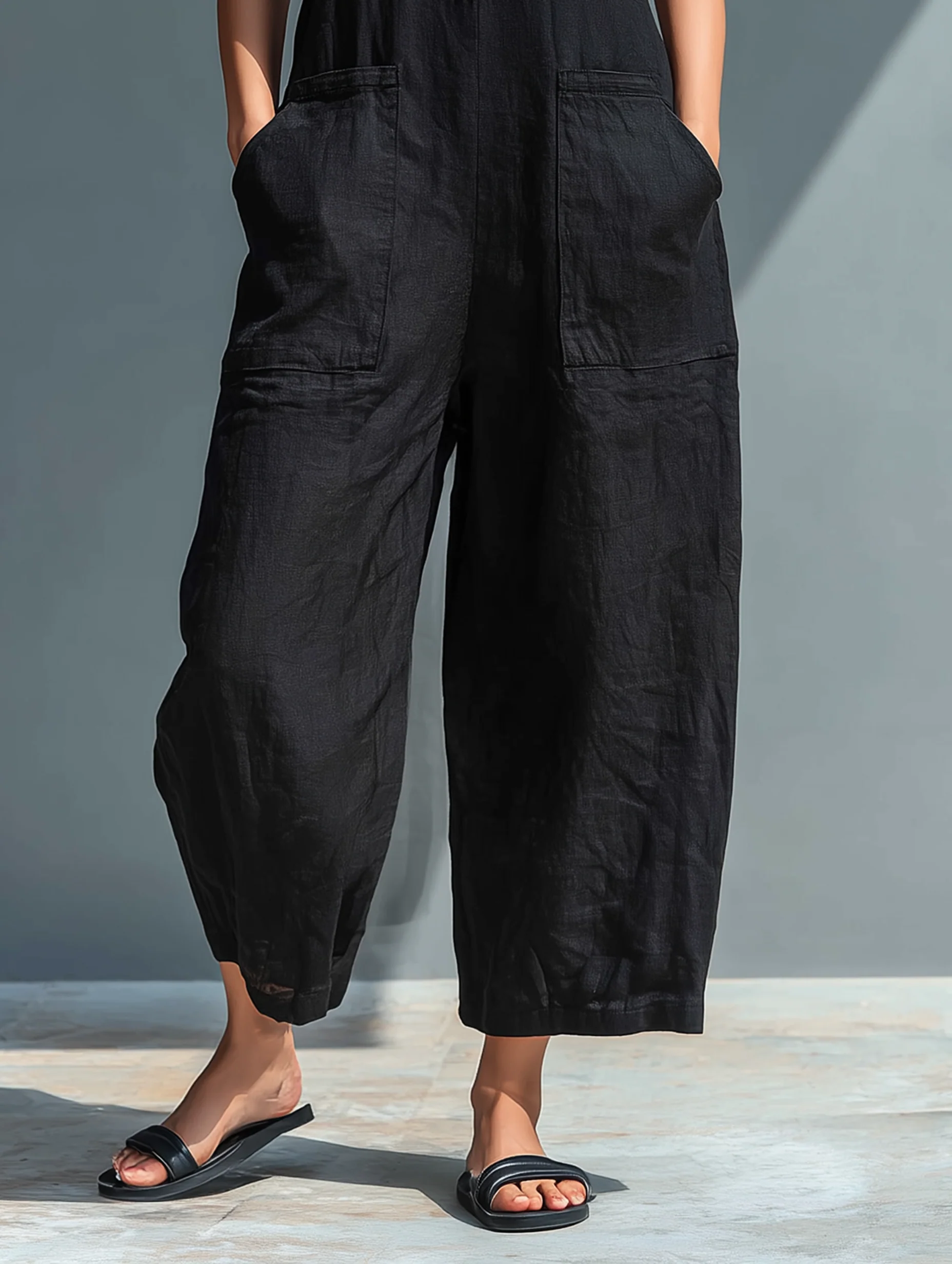 Aria Johnson | Sleeveless Loose-Fit Linen Jumpsuit in Black